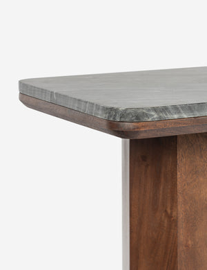 Close up of the Phan pillar-leg, marble-top console table.