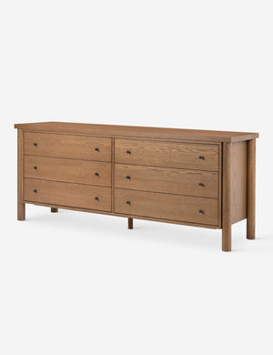 Angled view of the Kisner natural grain oak dresser.