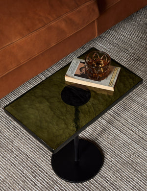 Bergen retro iron frame and glass top side table styled with a leather sofa and neutral striped rug.