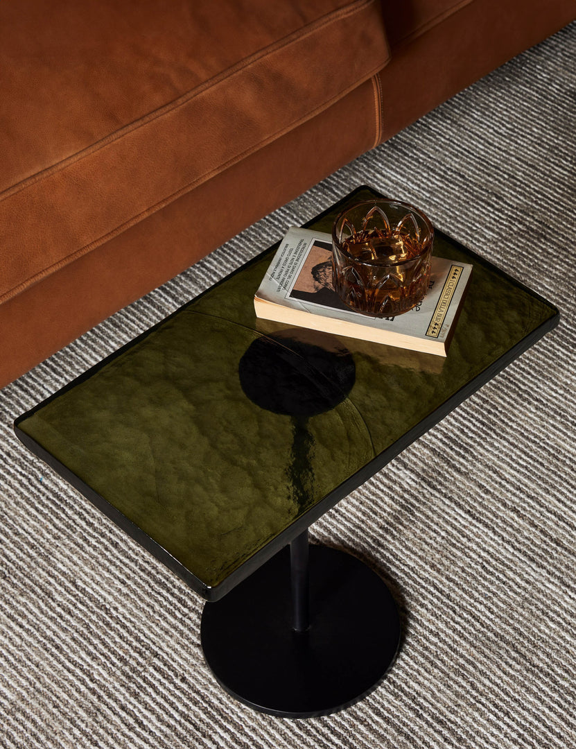 #color::black | Bergen retro iron frame and glass top side table styled with a leather sofa and neutral striped rug.