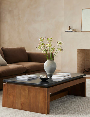 Brickell solid oak and marble top waterfall coffee table styled with a brown sofa and neutral rug.