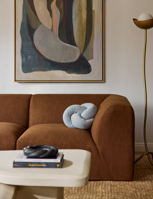 The Dewey velvet knot ball pillow styled on a sofa.