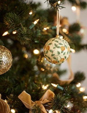 Joelle paper mache ornament hanging on a christmas tree