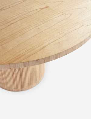 Close up of the wood grain of the Elvia round rattan stacked leg dining table