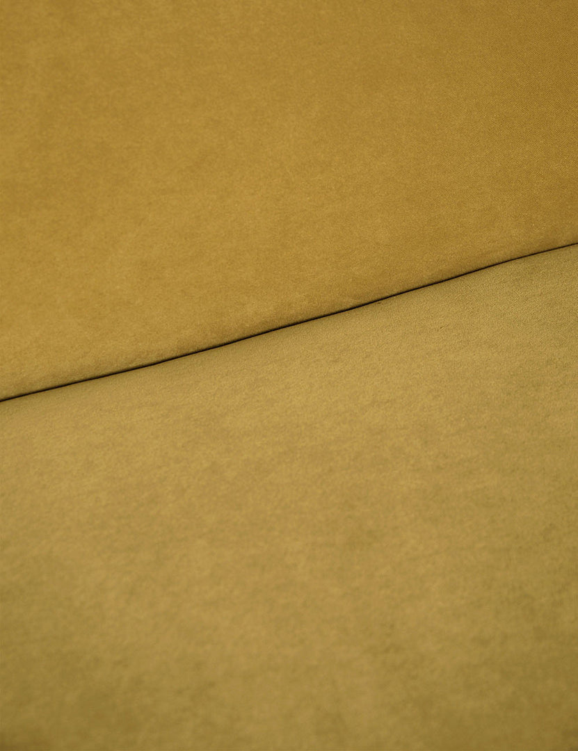 #color::Goldenrod-Velvet | Where the back and seat of the Lena Goldenrod Velvet armless sofa meet