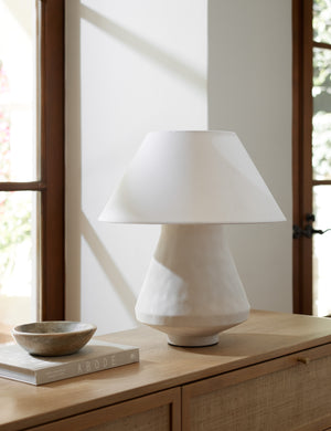 Vincente sculptural ceramic table lamp styled on a natural wood dresser.