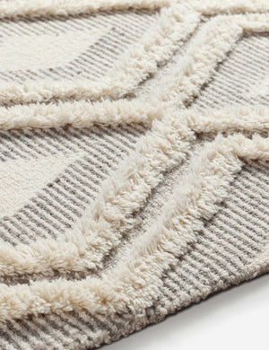 Close-up of the tufting on the Era wool diamond tufted geometric high-low area rug.