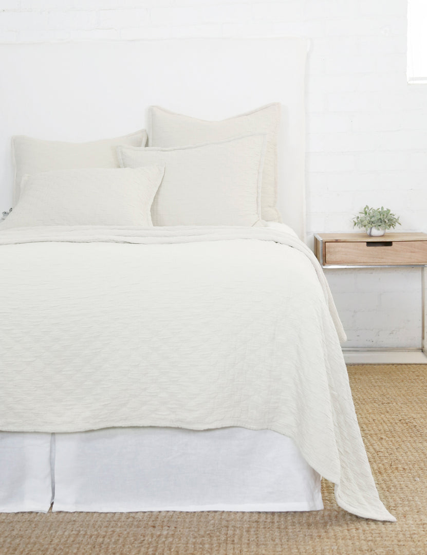 #color::greige #size::euro | Ojai Cotton Matelasse Greige Euro Sham by Pom Pom at Home sits on a white framed bed with other Ojaj greige linens