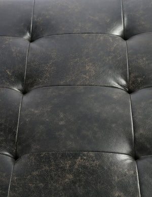 Close-up of the tufted black leather construction of the Patrizia Leather Coffee Table