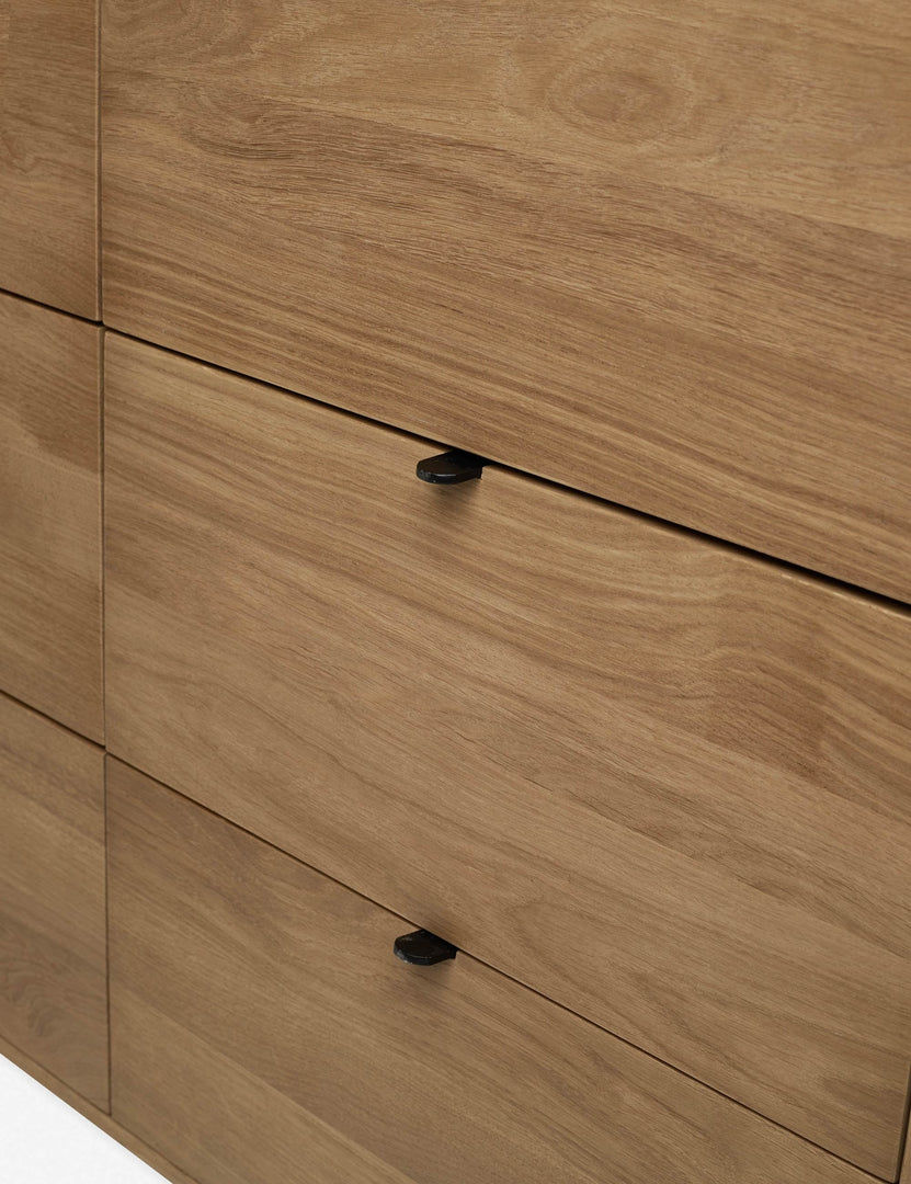 | The meta drawer pulls of the Kono 6-drawer curved oak wide dresser.