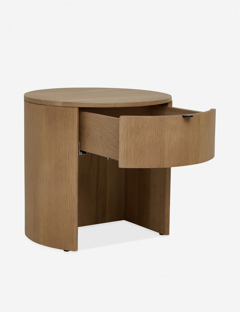 | Angled left view with the drawer opened on the Kono round solid oak nightstand with one drawer